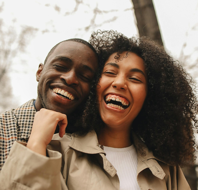 Couple standing together outside in the fall