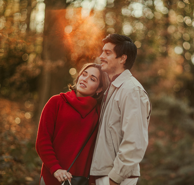 Couple hugging and standing outside during sunrise